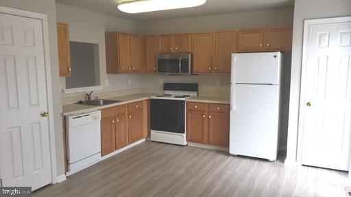 4 Bridle Path Wilmington, DE 19808 - Photo 6 of 14 a kitchen with a refrigerator sink and cabinets