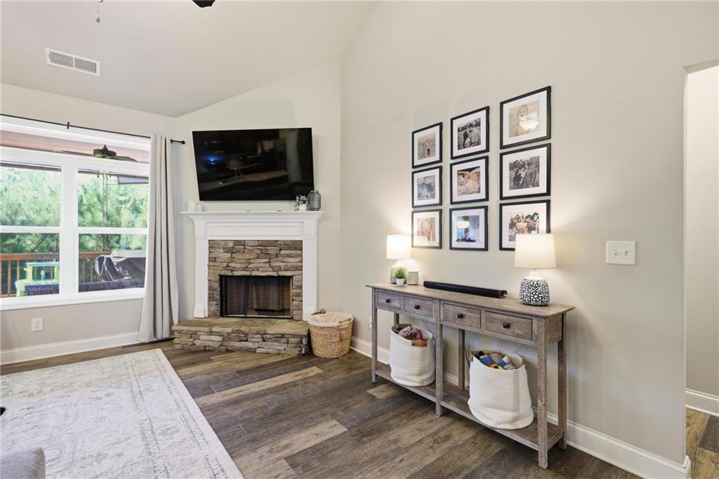 47 Violet Lane Dallas, GA 30132 - Photo 7 of 27 a living room with stainless steel appliances furniture a fireplace and a flat screen tv