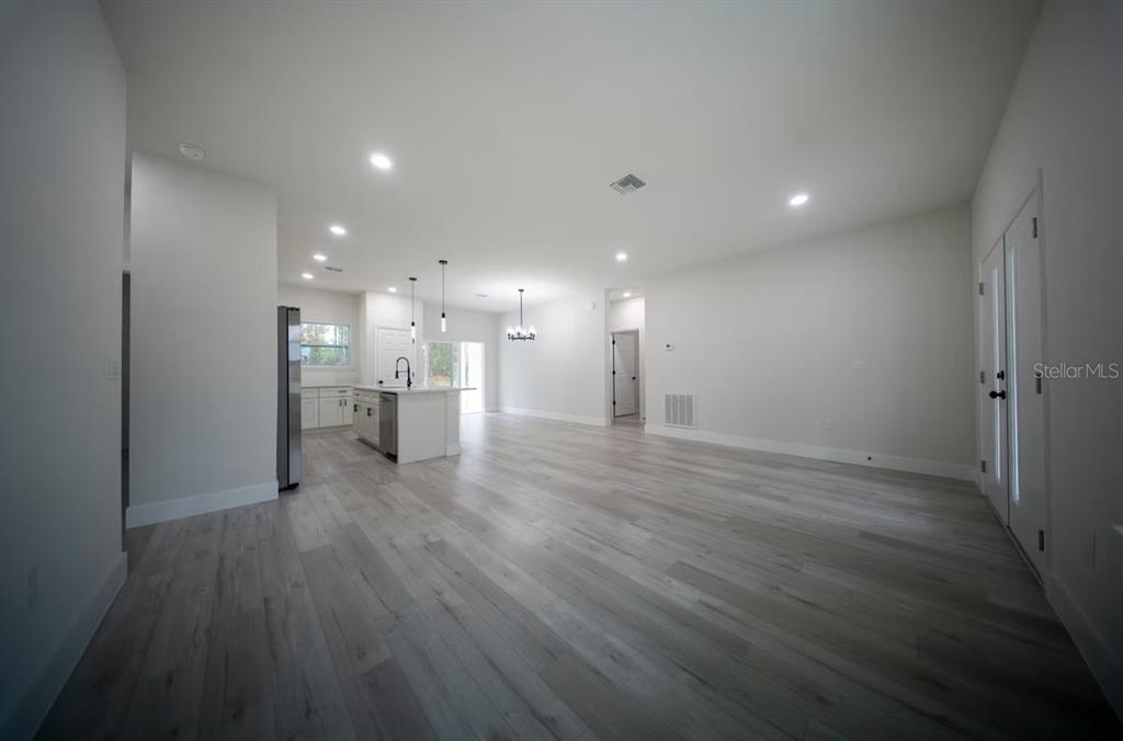 6442 North Sandborn Loop Citrus Springs, FL 34433 - Photo 12 of 33 a view of a big room with wooden floor and a window