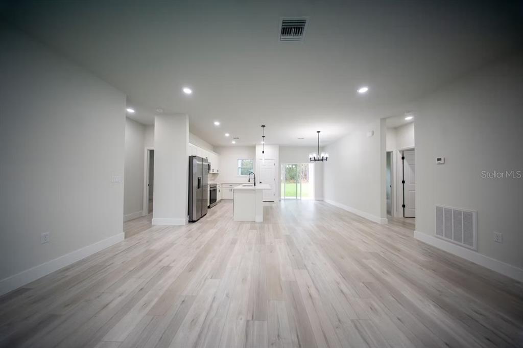 6442 North Sandborn Loop Citrus Springs, FL 34433 - Photo 14 of 33 a view of a big room with wooden floor and a window