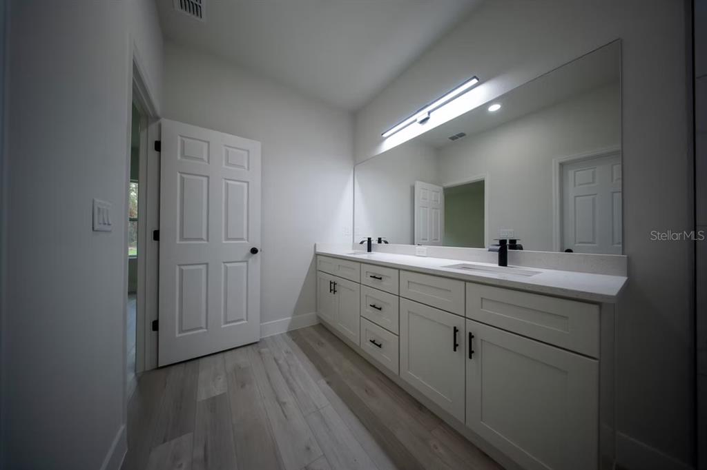 6442 North Sandborn Loop Citrus Springs, FL 34433 - Photo 15 of 33 a spacious bathroom with a double vanity sink and mirror