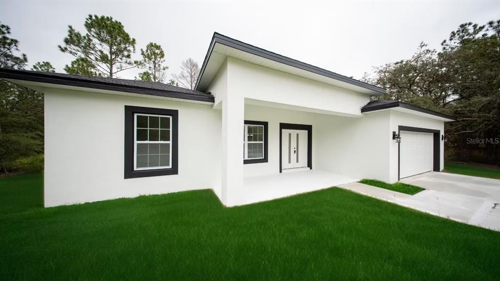 6442 North Sandborn Loop Citrus Springs, FL 34433 - Photo 2 of 33 a view of an house with backyard space and garden