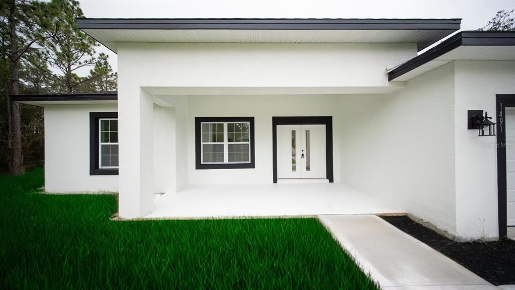 6442 North Sandborn Loop Citrus Springs, FL 34433 - Photo 3 of 33 a front view of a house with a yard