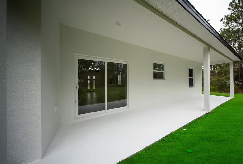 6442 North Sandborn Loop Citrus Springs, FL 34433 - Photo 33 of 33 a view of an house with backyard porch and garden
