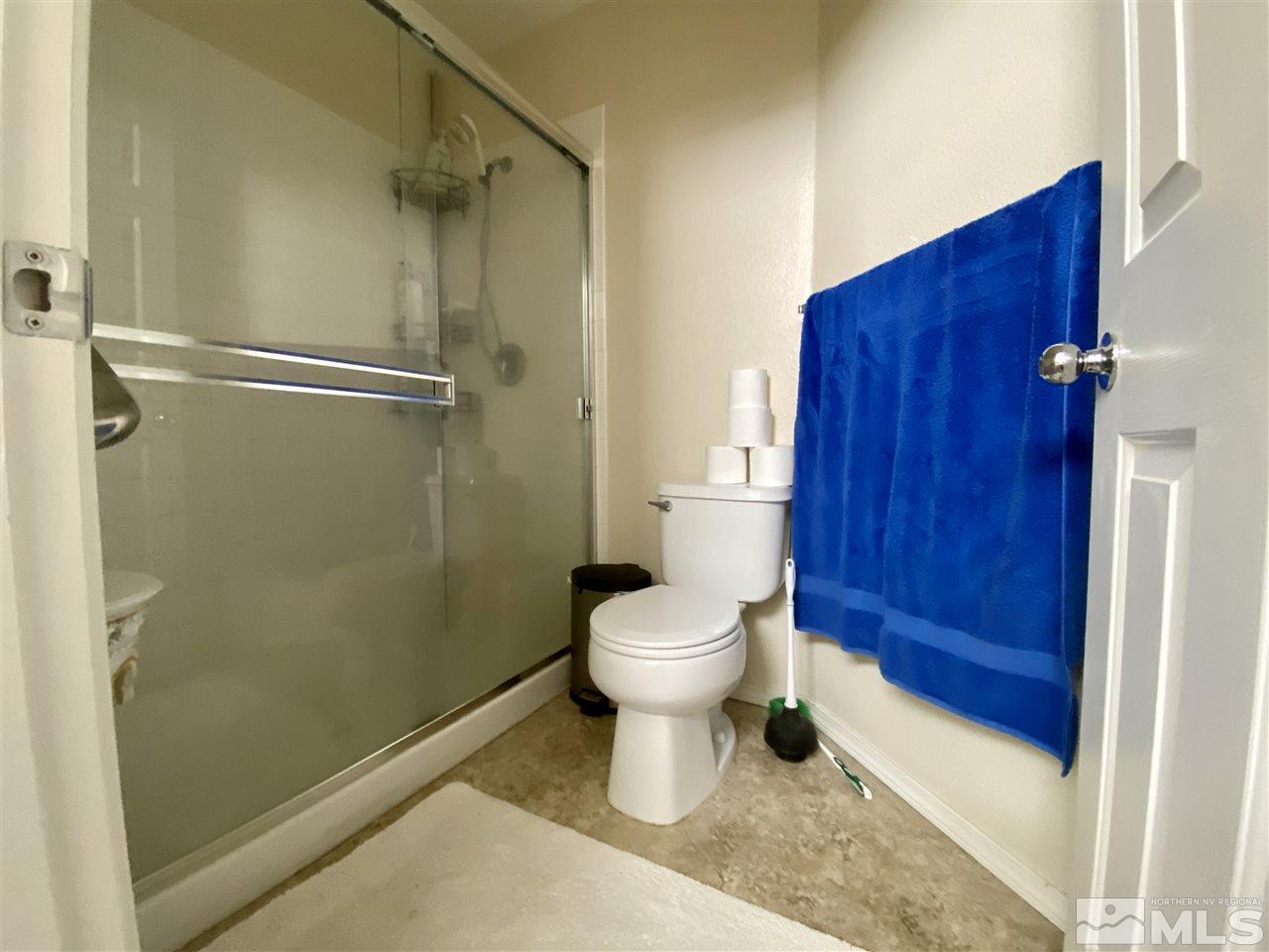 1645 Westmont Lane Reno, NV 89521 - Photo 12 of 16 a bathroom with a toilet and a shower