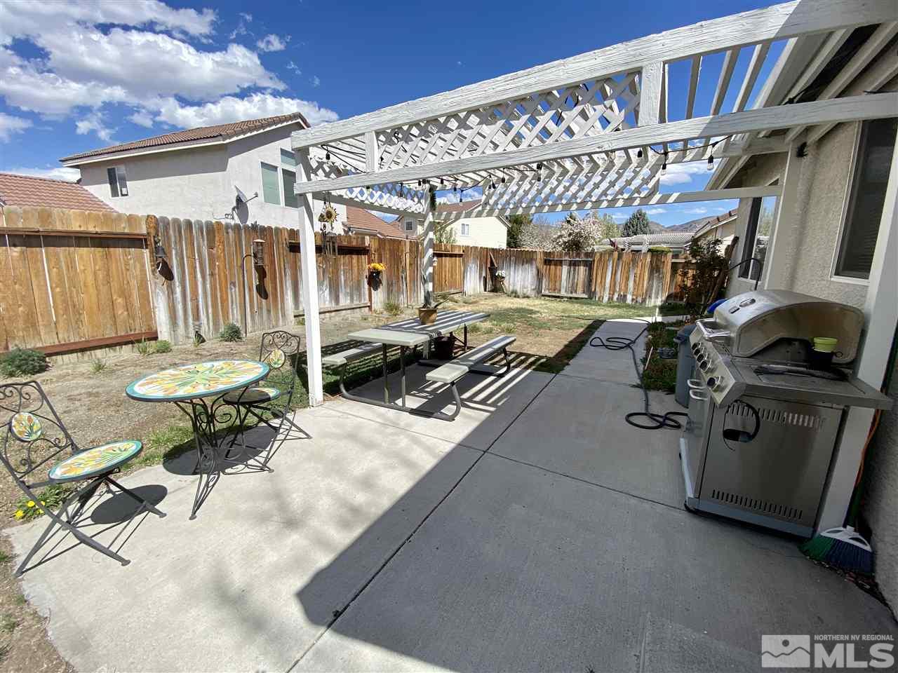 1645 Westmont Lane Reno, NV 89521 - Photo 15 of 16 a roof deck with table and chairs with potted plants