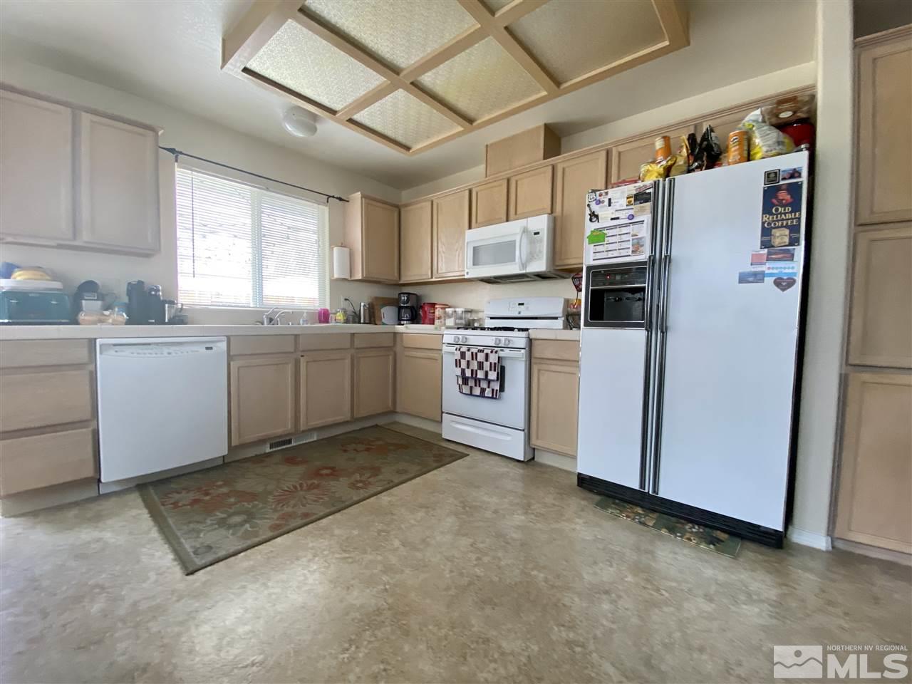 1645 Westmont Lane Reno, NV 89521 - Photo 4 of 16 a kitchen with refrigerator and window