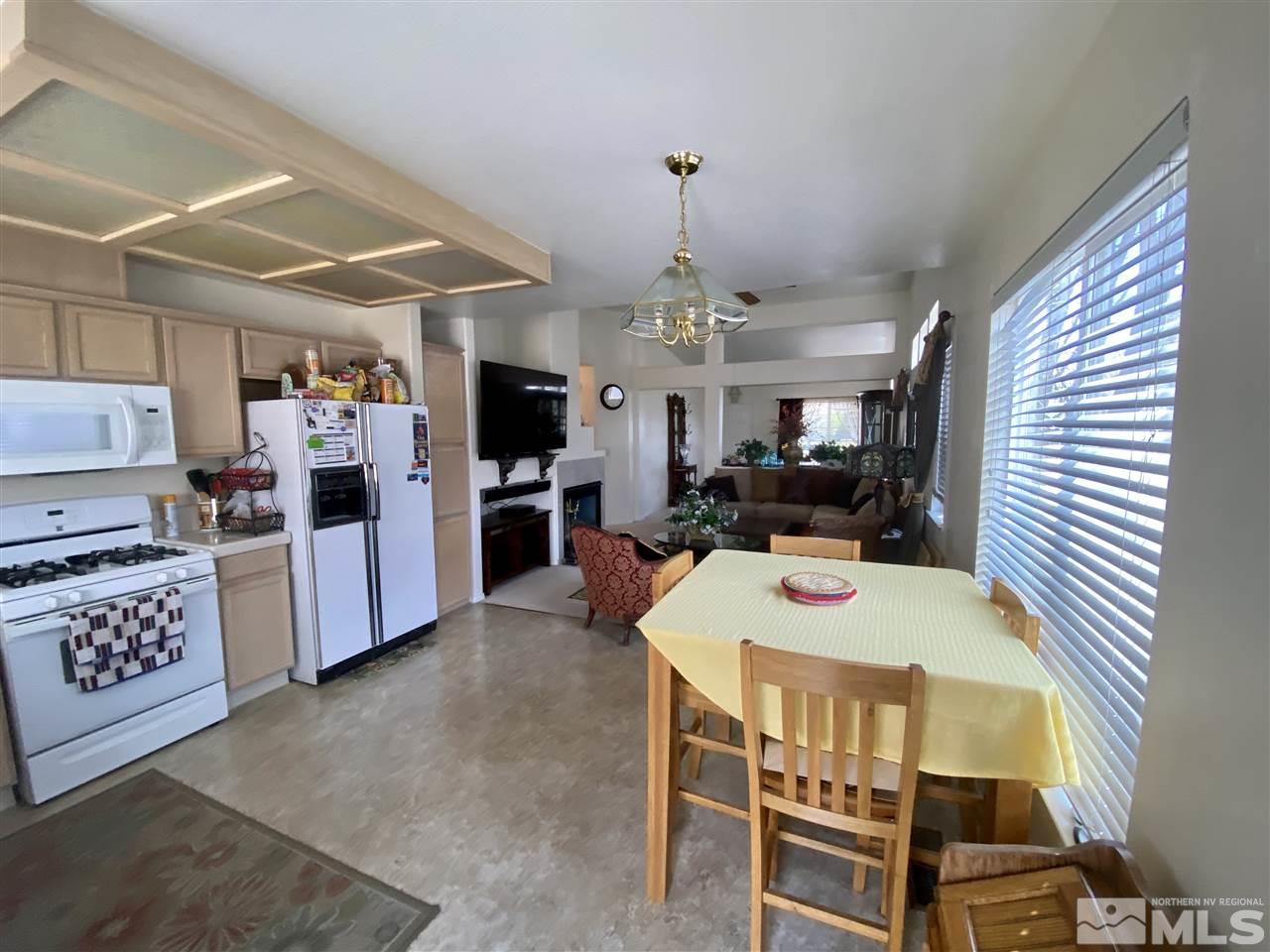 1645 Westmont Lane Reno, NV 89521 - Photo 5 of 16 a view of a dining room with furniture and a kitchen