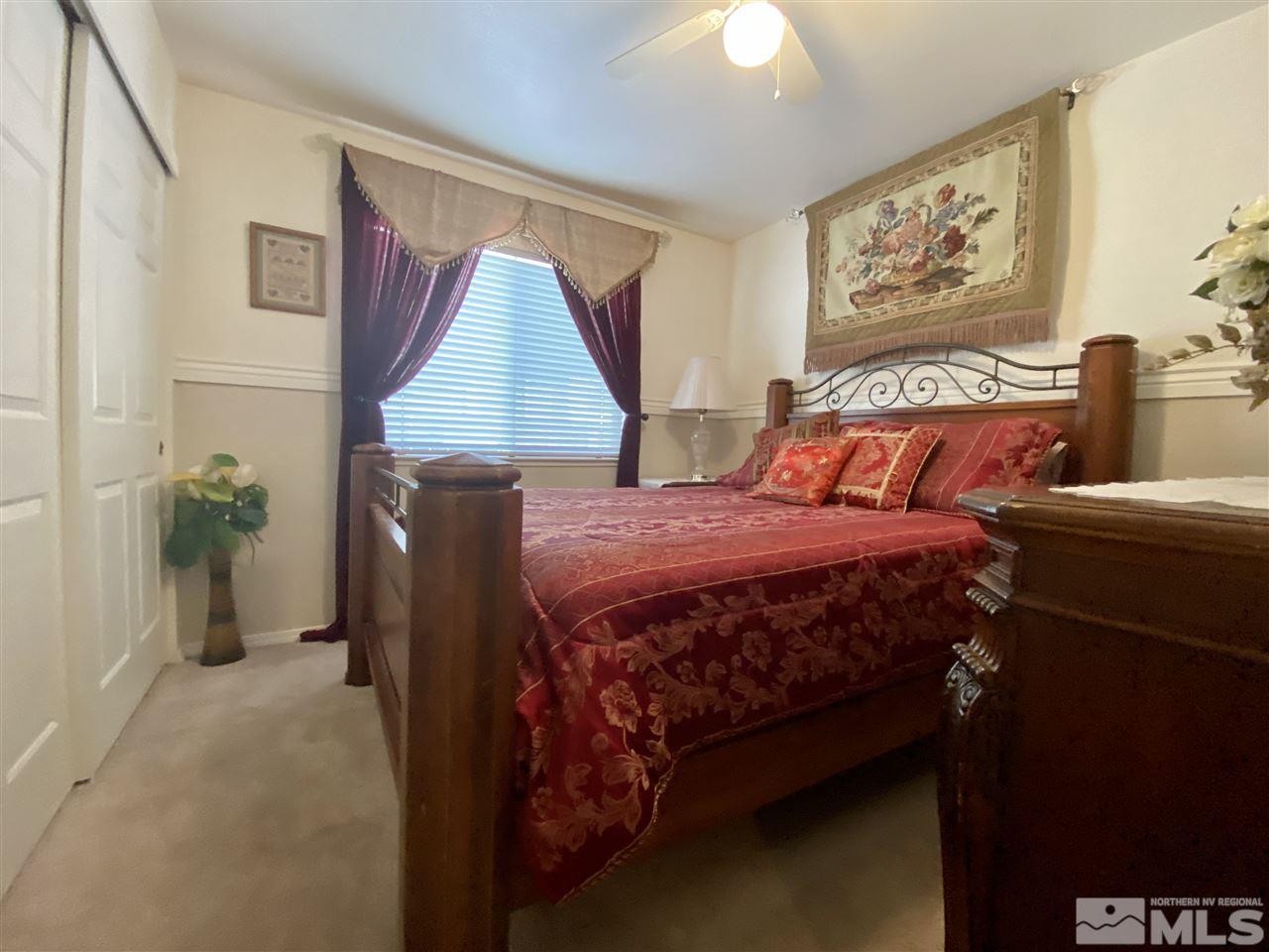 1645 Westmont Lane Reno, NV 89521 - Photo 6 of 16 a bedroom with a bed and a painting on the wall