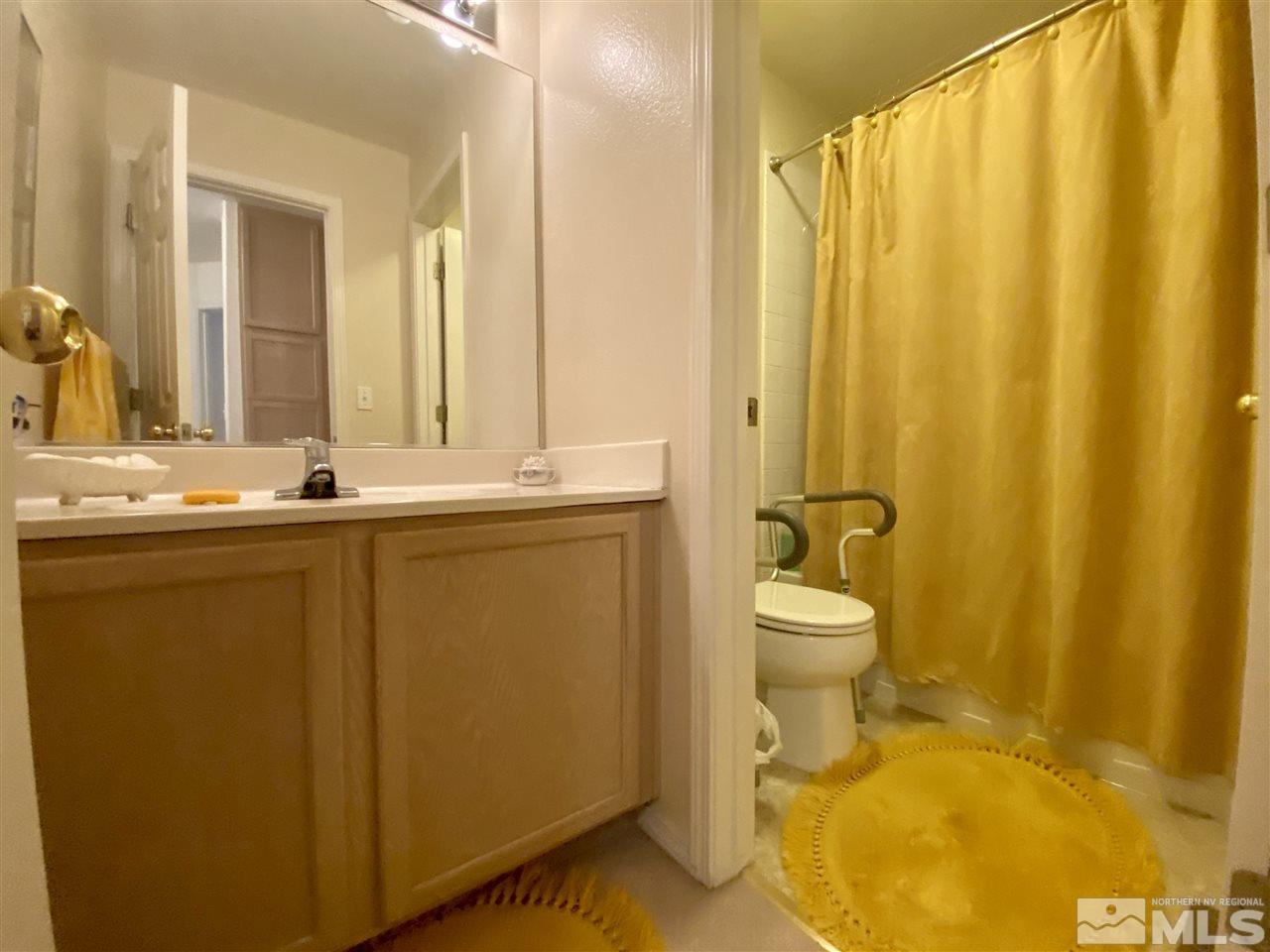 1645 Westmont Lane Reno, NV 89521 - Photo 8 of 16 a bathroom with a sink a toilet and mirror