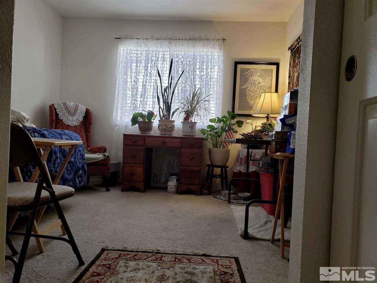 1645 Westmont Lane Reno, NV 89521 - Photo 9 of 16 a living room with furniture and a potted plant