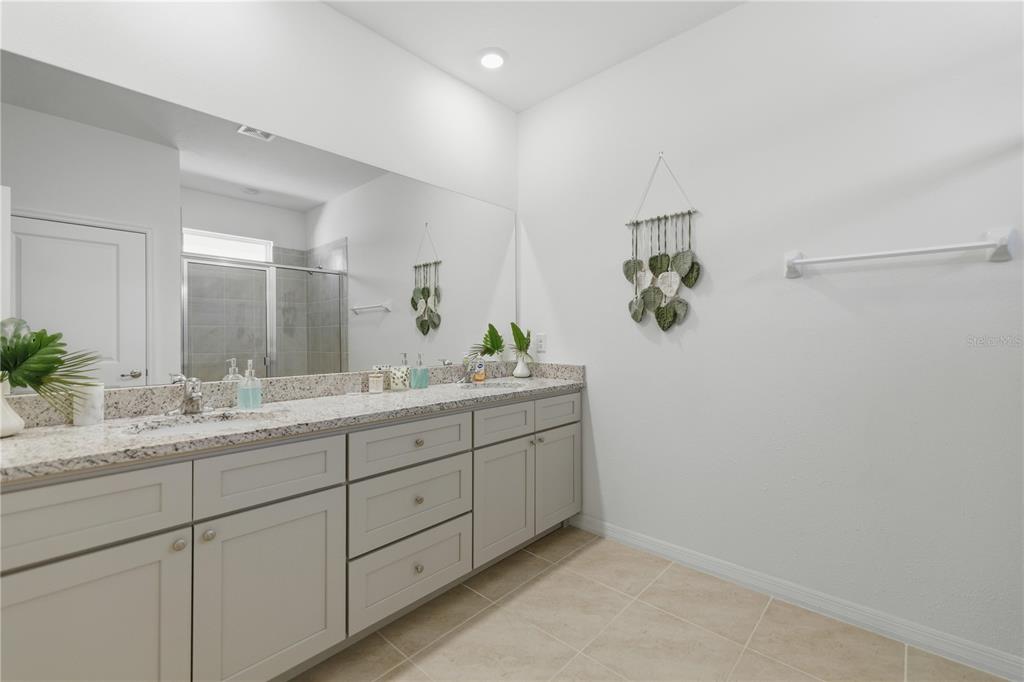 5157 Northwest 43rd Ln Road Ocala, FL 34482 - Photo 11 of 70 a bathroom with a granite countertop sink and a mirror