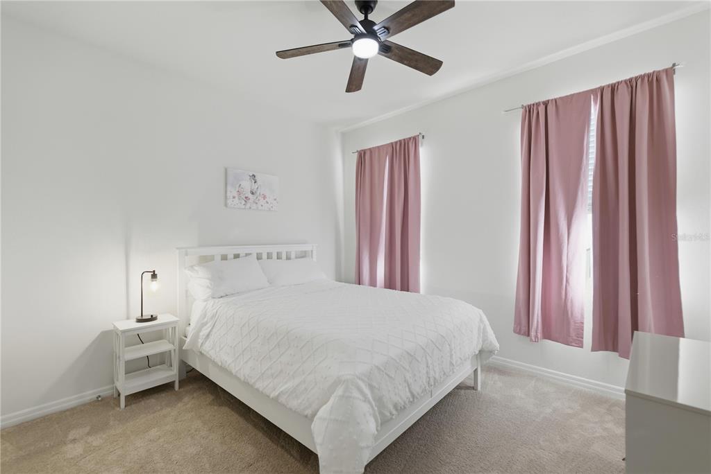 5157 Northwest 43rd Ln Road Ocala, FL 34482 - Photo 13 of 70 a bedroom with a bed and a chandelier