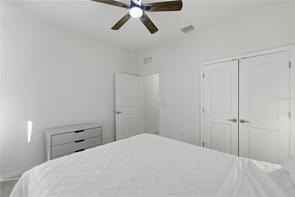 a bedroom with a bed and window