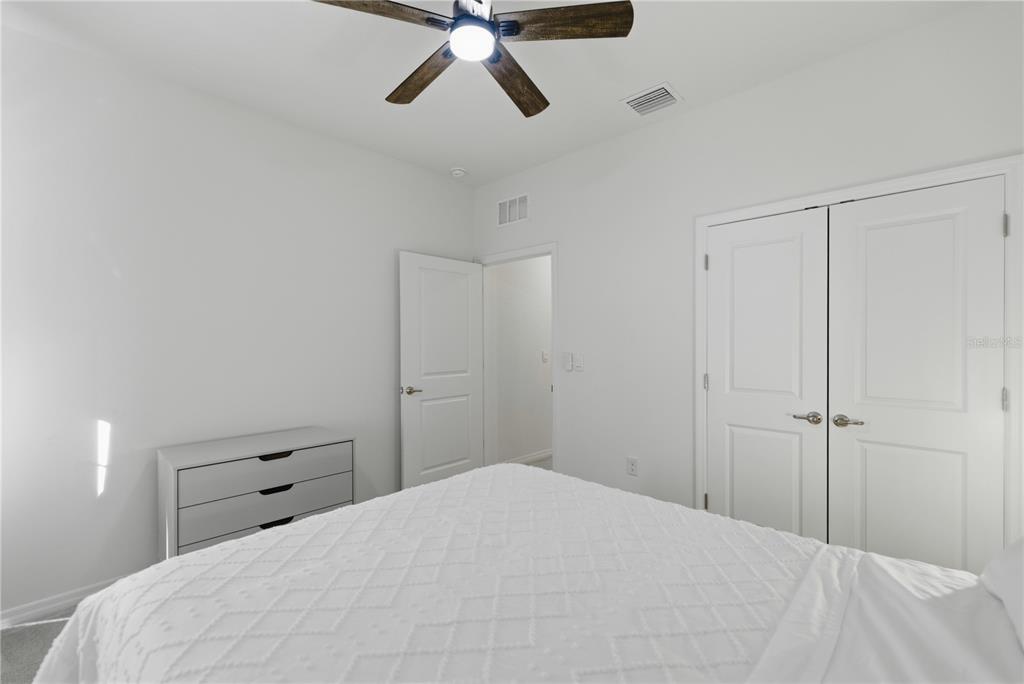 5157 Northwest 43rd Ln Road Ocala, FL 34482 - Photo 14 of 70 a bedroom with a bed and a chandelier