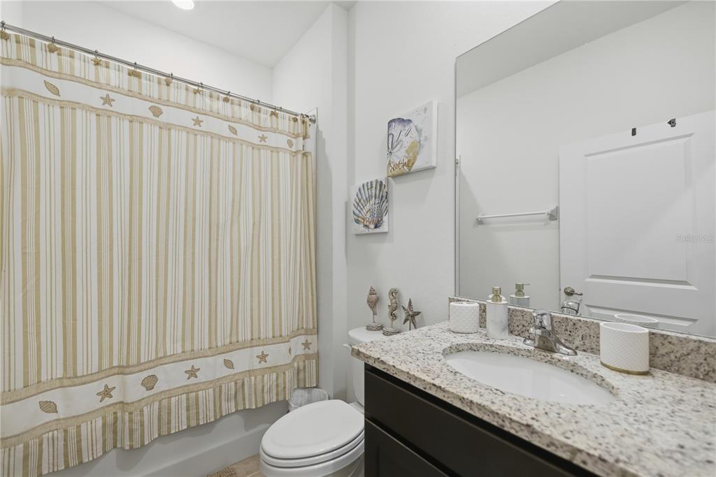 5157 Northwest 43rd Ln Road Ocala, FL 34482 - Photo 15 of 70 a bathroom with a granite countertop sink a toilet and shower