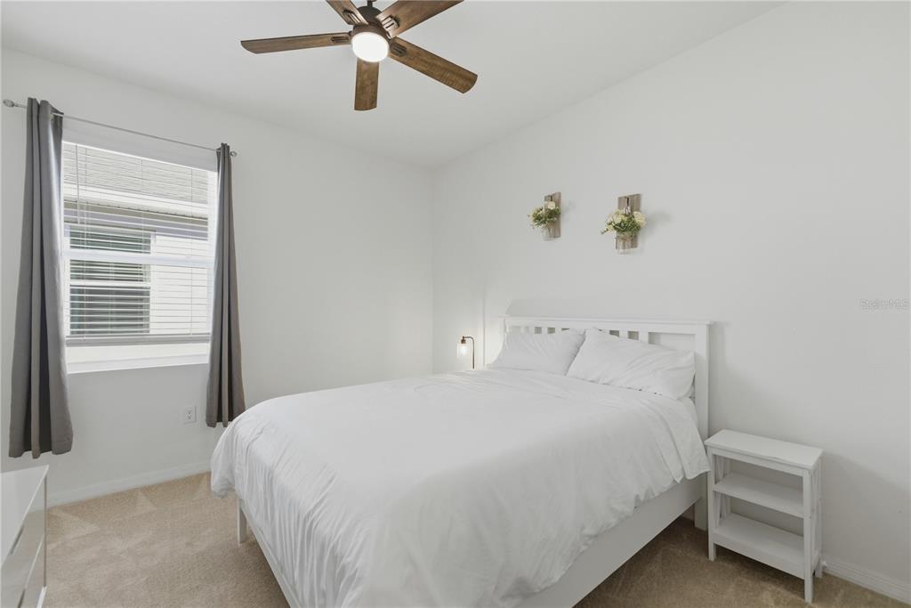 5157 Northwest 43rd Ln Road Ocala, FL 34482 - Photo 18 of 70 a bedroom with a bed and a chandelier