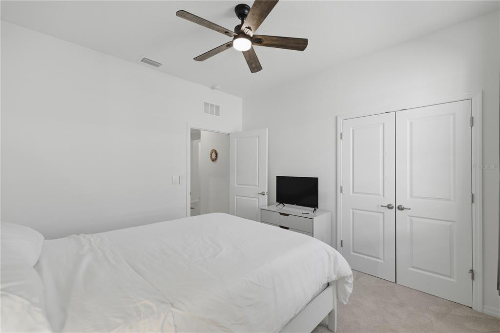 5157 Northwest 43rd Ln Road Ocala, FL 34482 - Photo 19 of 70 a bedroom with a bed and a flat tv screen