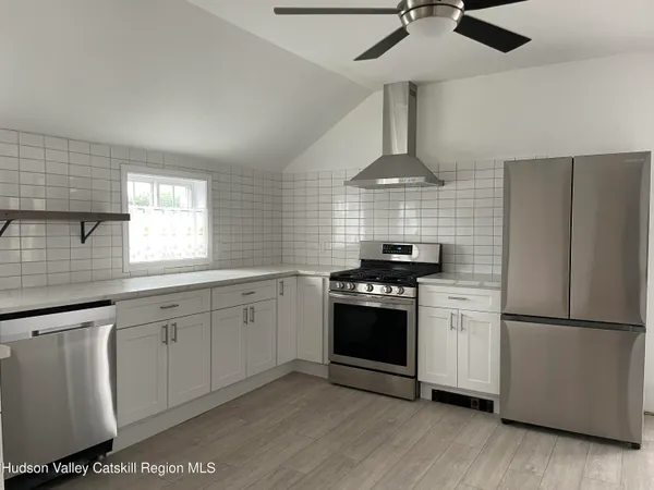 a kitchen with stainless steel appliances granite countertop a stove a refrigerator and a sink