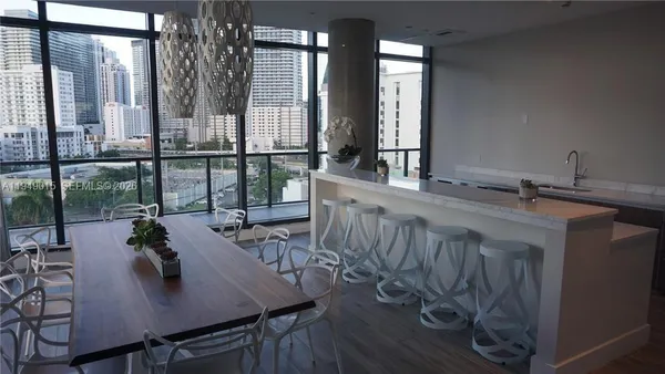 a view of a dining room with furniture and window