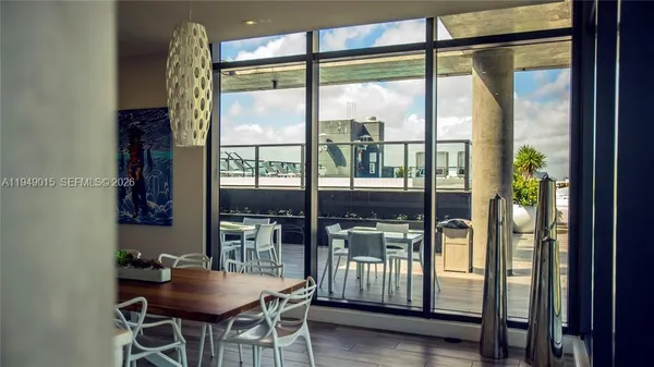 a dining room with furniture and window