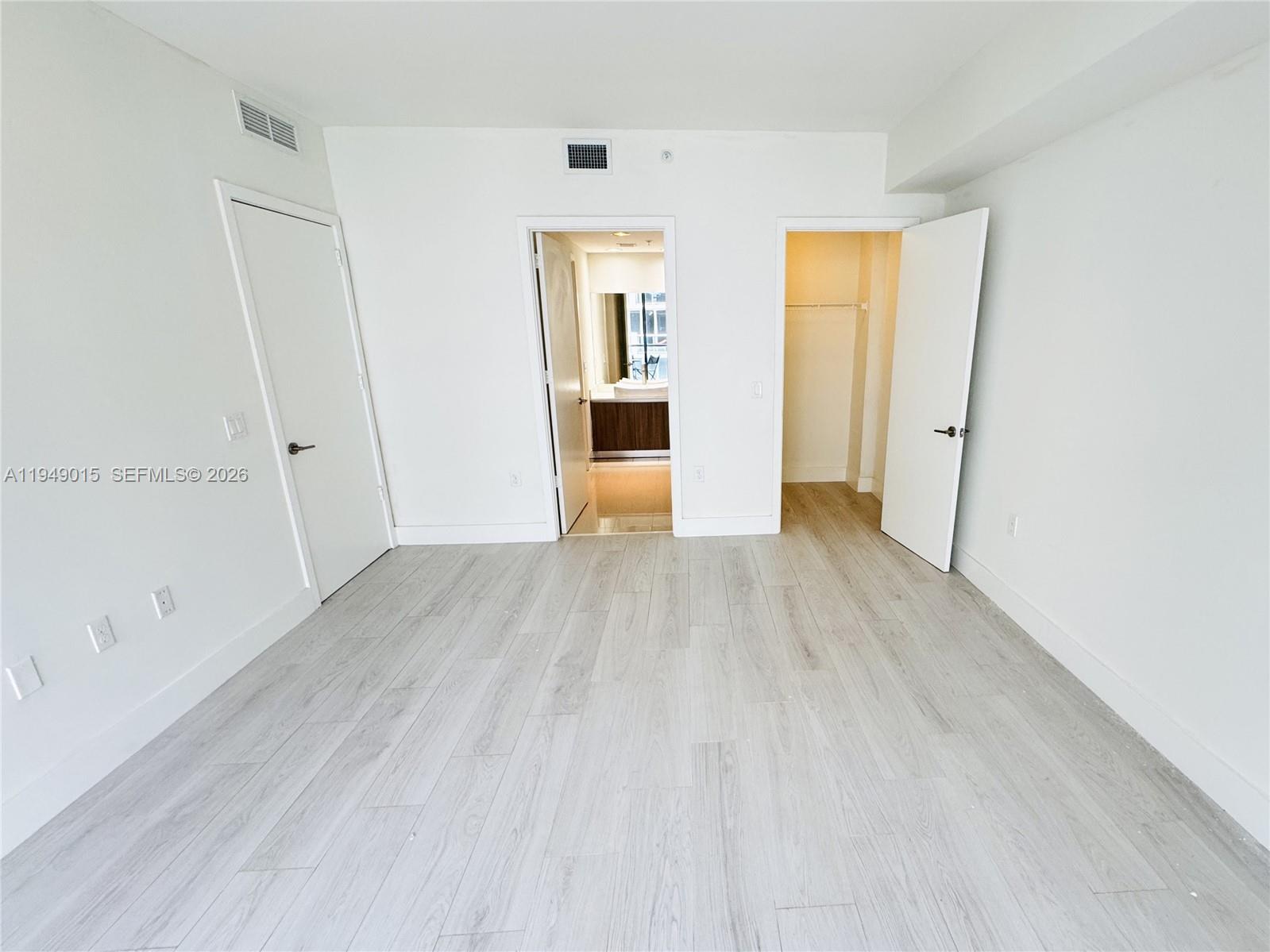 201 Southwest 17th Road, Unit 603 Miami, FL 33129 - Photo 6 of 23 a view of a big room with wooden floor and windows