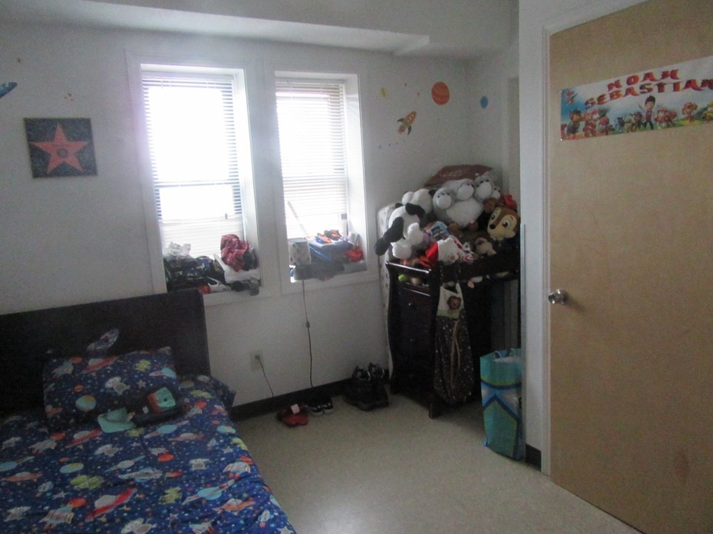 47 White Street Springfield, MA 01108 - Photo 7 of 16 a room with water heater and wooden floor