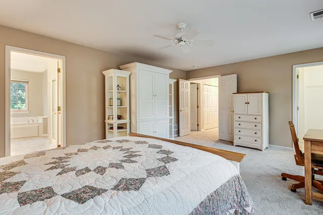 a bedroom with a dresser and a window
