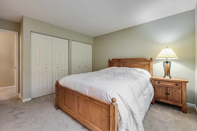 a bedroom with a bed and a lamp