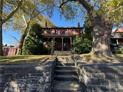 a view of a house with street next to a road