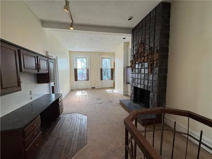a view of livingroom with fireplace and cabinet