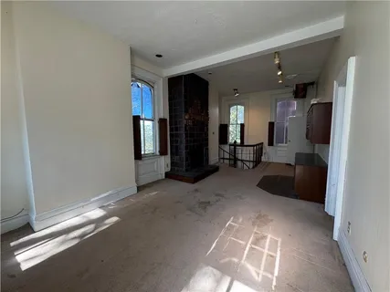 a bathroom with a granite countertop sink a mirror and shower