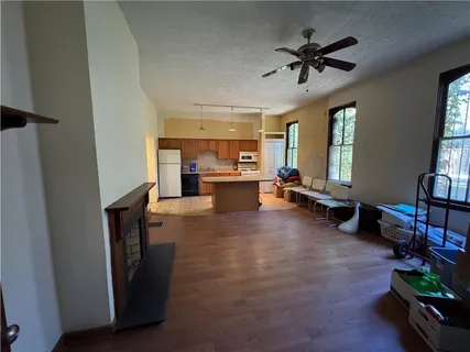 a view of a livingroom with wooden floor and windows