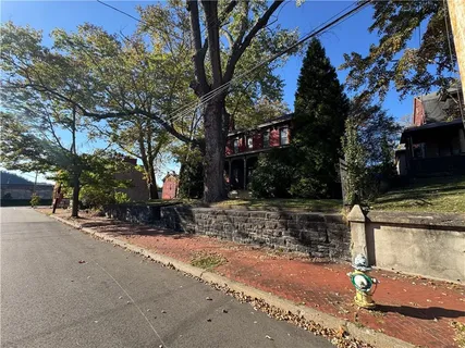 a view of a tree in front of a house