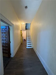 a view of entryway and hall with wooden floor