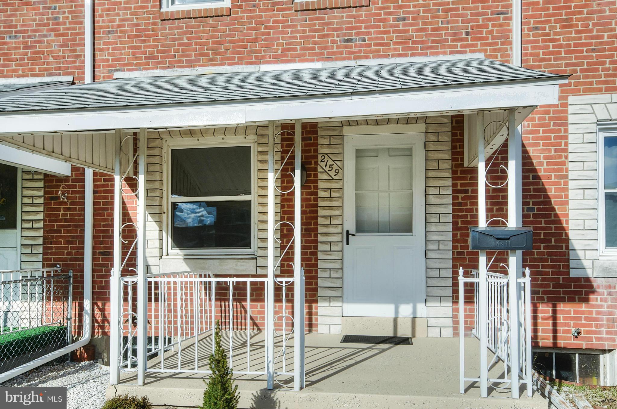 2159 Coralthorn Road Baltimore, MD 21220 - Photo 16 of 16 a view of a brick house with large windows