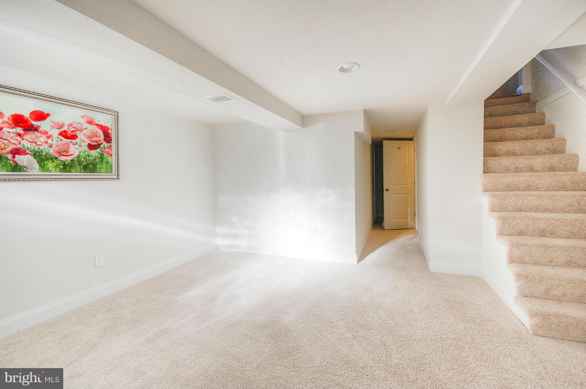 2159 Coralthorn Road Baltimore, MD 21220 - Photo 6 of 16 a view of an empty room with stairs