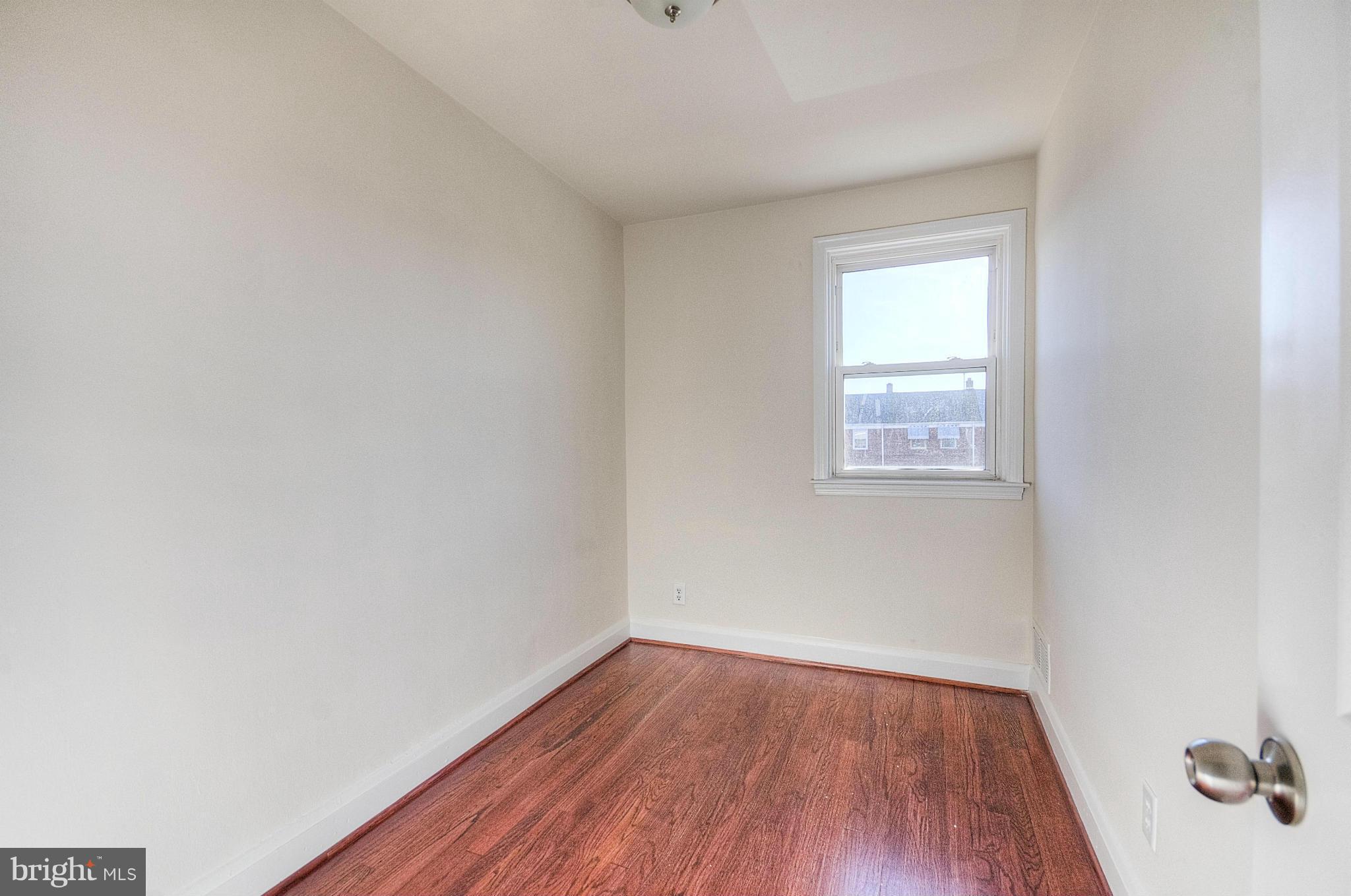 2159 Coralthorn Road Baltimore, MD 21220 - Photo 9 of 16 a view of an empty room with wooden floor and a window