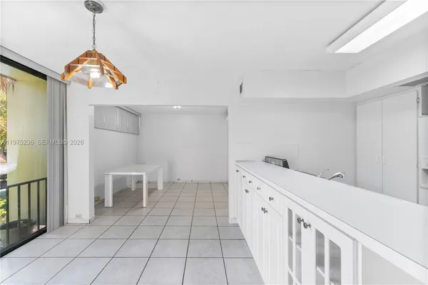 a kitchen with a sink a stove a refrigerator and cabinets