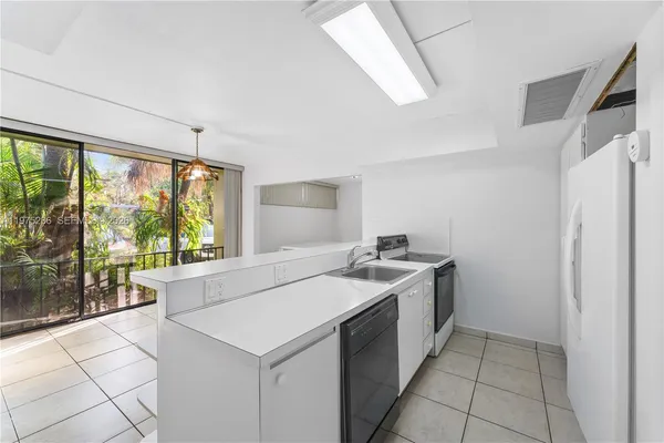 a kitchen with a stove and a refrigerator