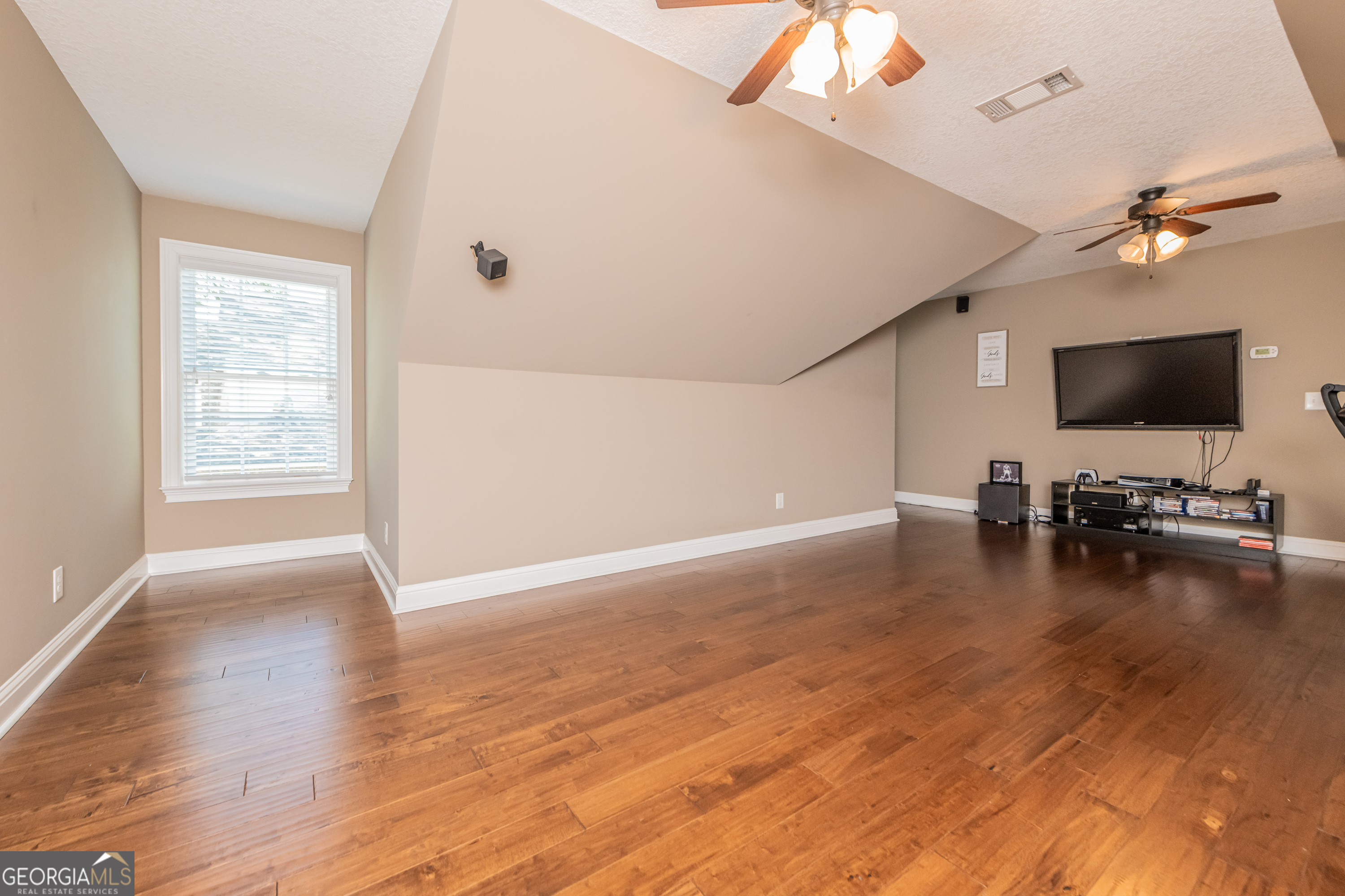 405 Old Bridge Road Warner Robins, GA 31088 - Photo 42 of 55 a view of a livingroom with wooden floor and a ceiling fan