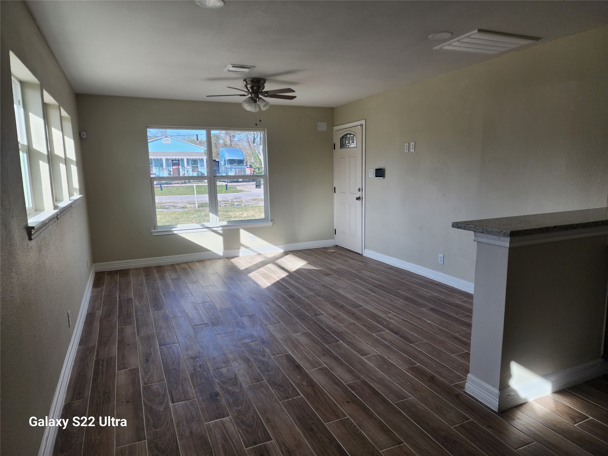 702 McDaniel Street, Unit B Houston, TX 77022 - Photo 3 of 8 wooden floor in an empty room with a window