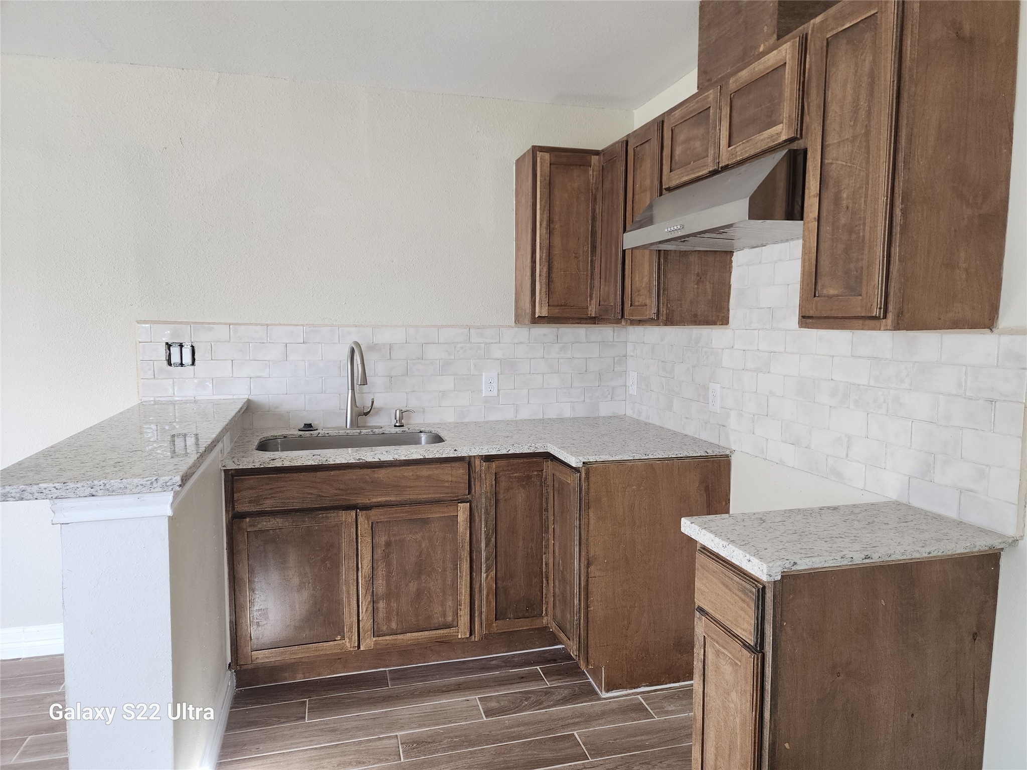 702 McDaniel Street, Unit B Houston, TX 77022 - Photo 4 of 8 a kitchen with stainless steel appliances granite countertop a sink and a stove