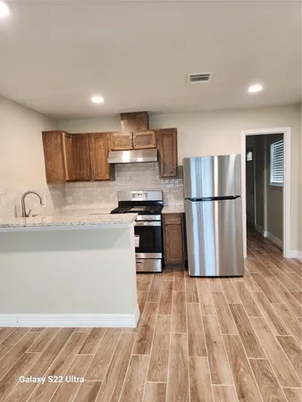 a kitchen with a refrigerator a sink and dishwasher
