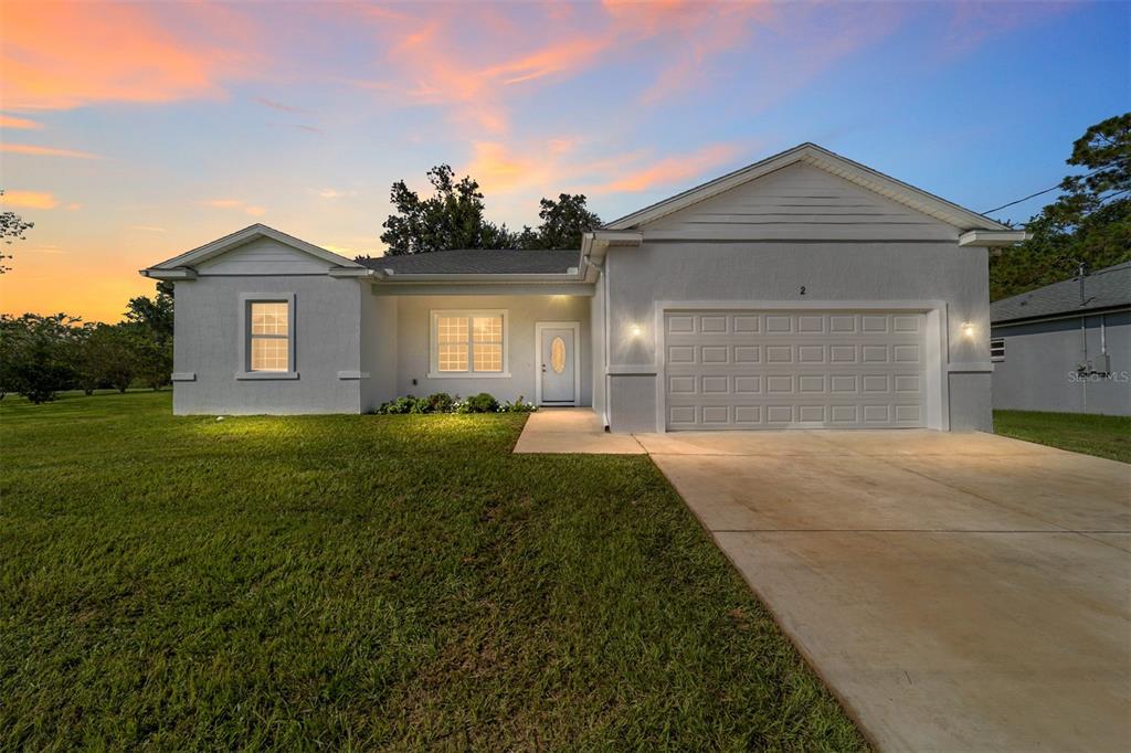 2 Locust Run Ocala, FL 34472 - Photo 1 of 1 a front view of a house with a yard and garage