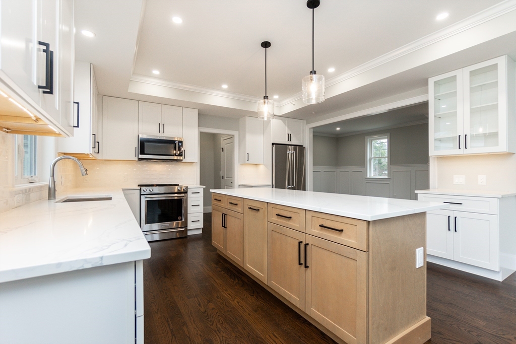 83 East Main Street Hopkinton, MA 01748 - Photo 13 of 42 a kitchen with stove a sink and refrigerator