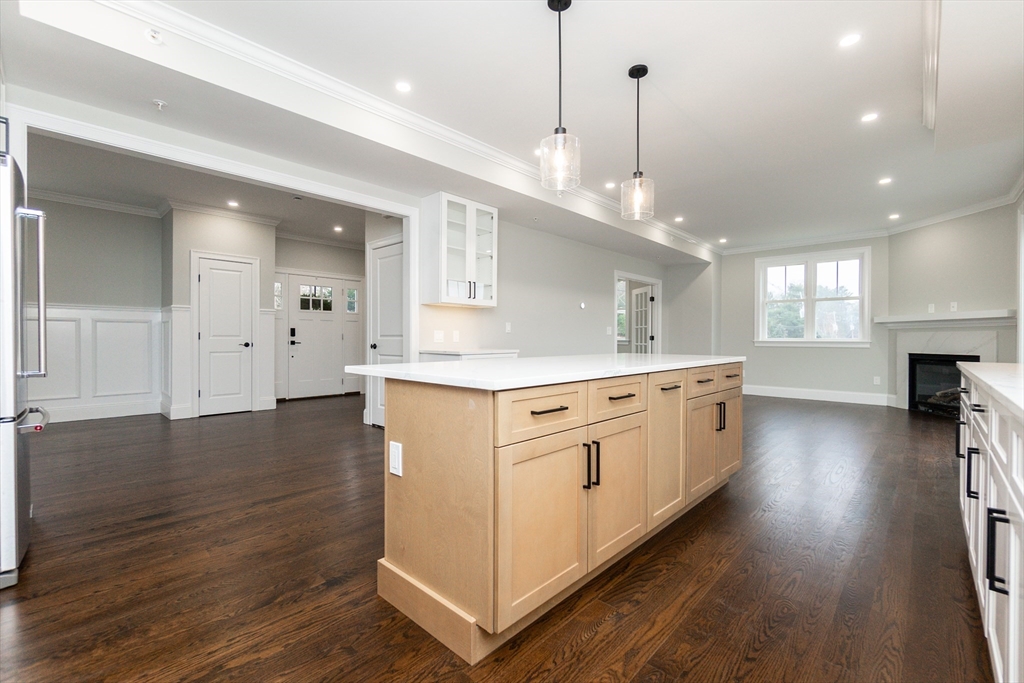 83 East Main Street Hopkinton, MA 01748 - Photo 14 of 42 a large white kitchen with lots of counter space wooden floor and stainless steel appliances