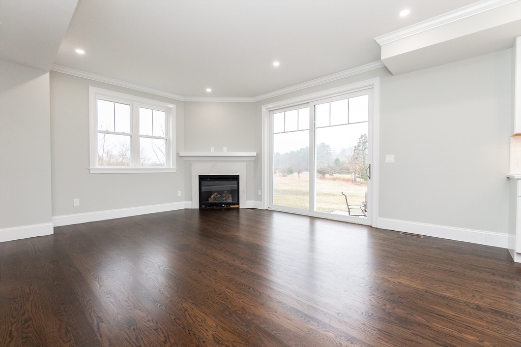 83 East Main Street Hopkinton, MA 01748 - Photo 16 of 42 a view of empty room with wooden floor and fireplace