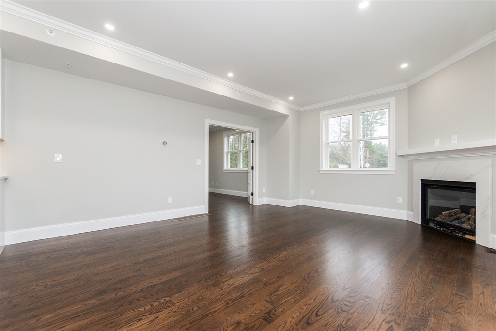 83 East Main Street Hopkinton, MA 01748 - Photo 18 of 42 an empty room with wooden floor and a fireplace