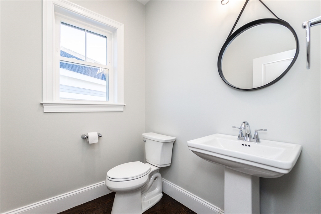 83 East Main Street Hopkinton, MA 01748 - Photo 19 of 42 a bathroom with a sink a toilet and a mirror